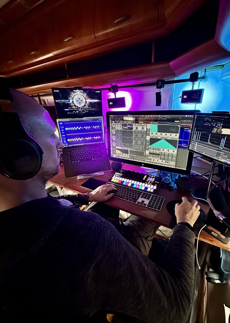 Adam Arcturus producing music at his studio desk